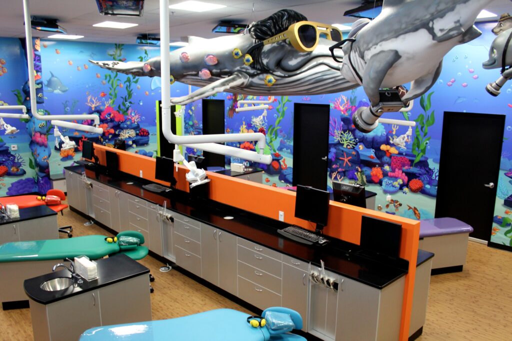 A dentist's office with a shark on the wall.