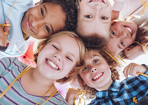 A group of children posing in a circle.