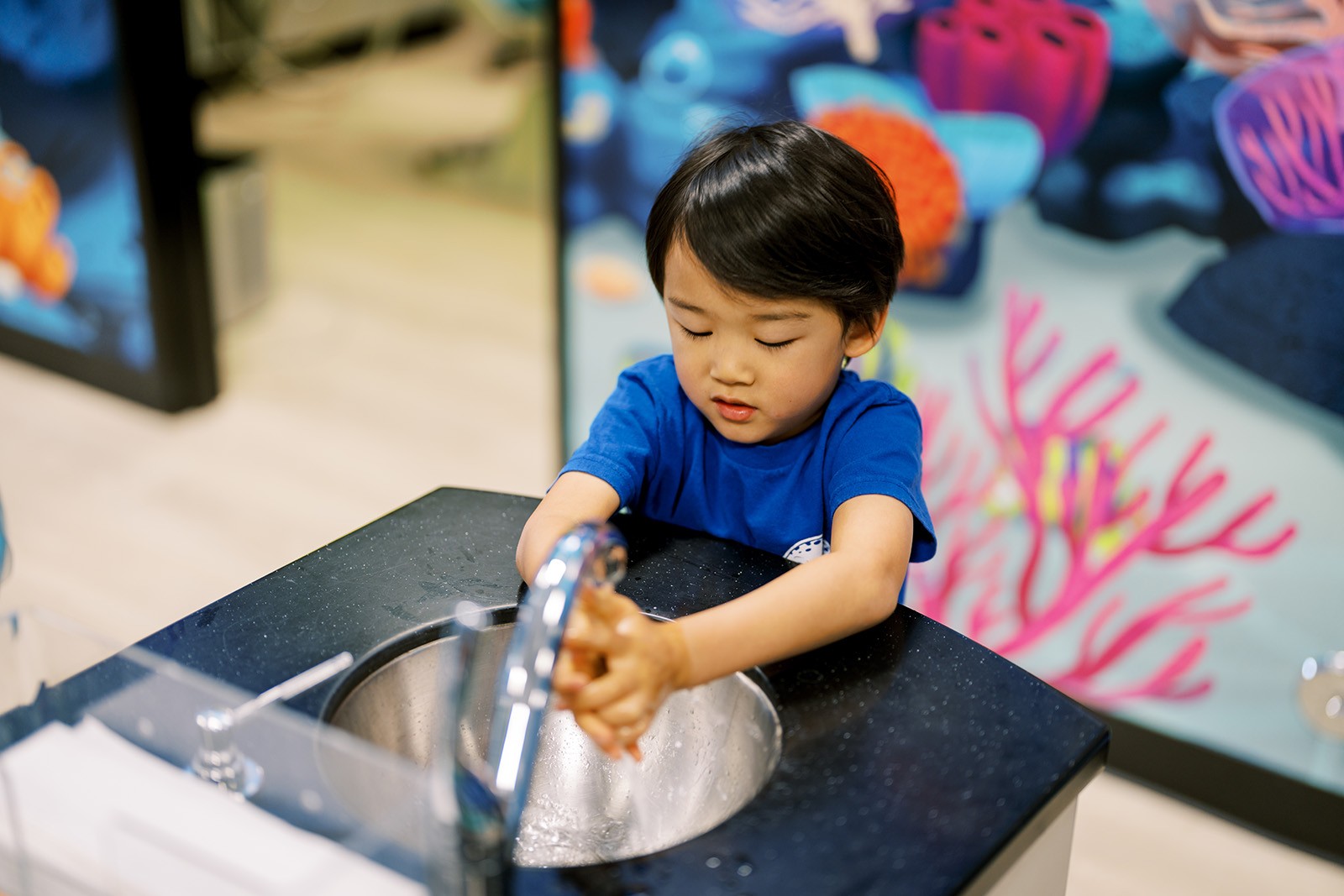A dentist's office with an orange chair and a window.